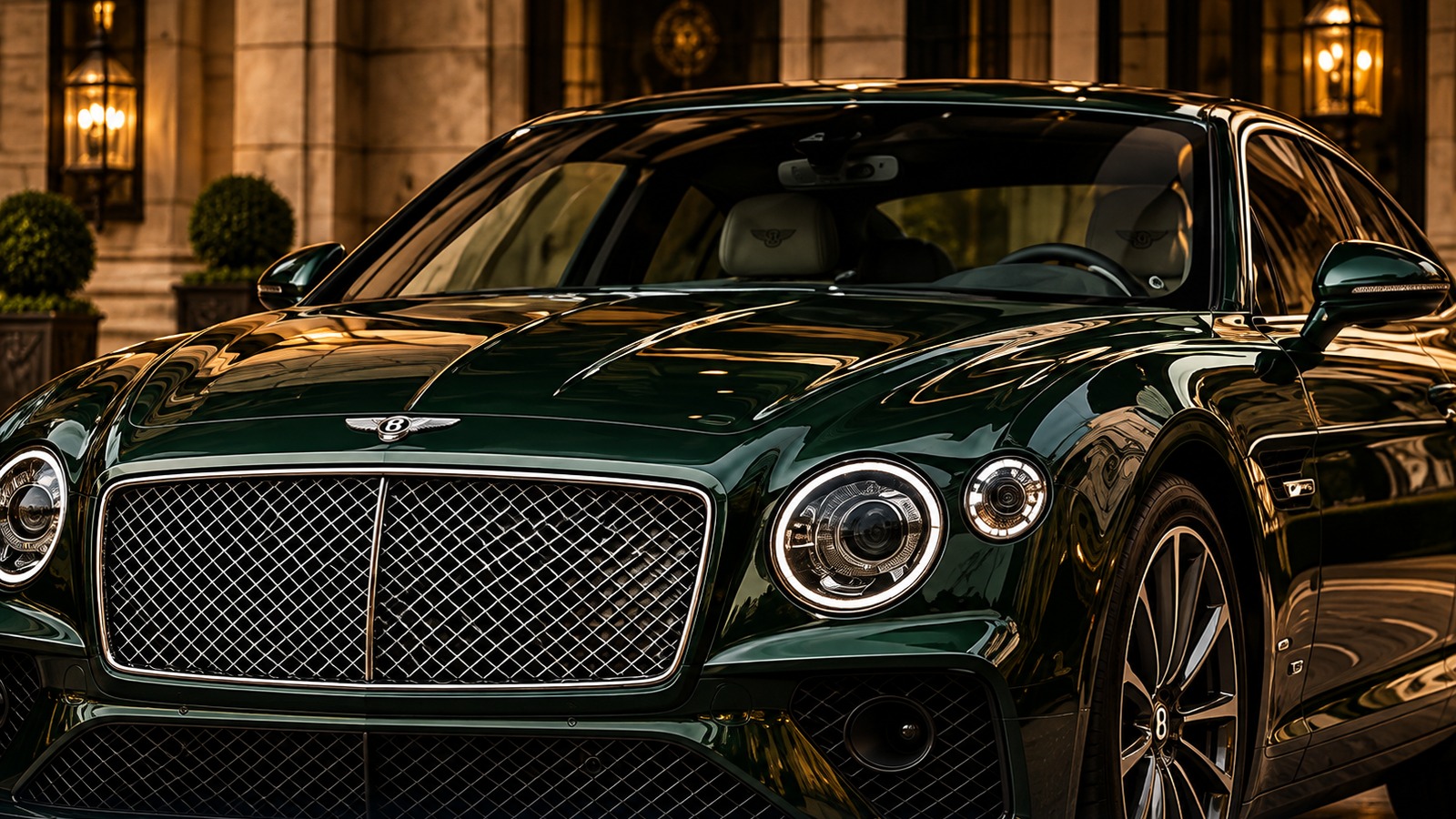 Dark green luxury saloon at a hotel entrance